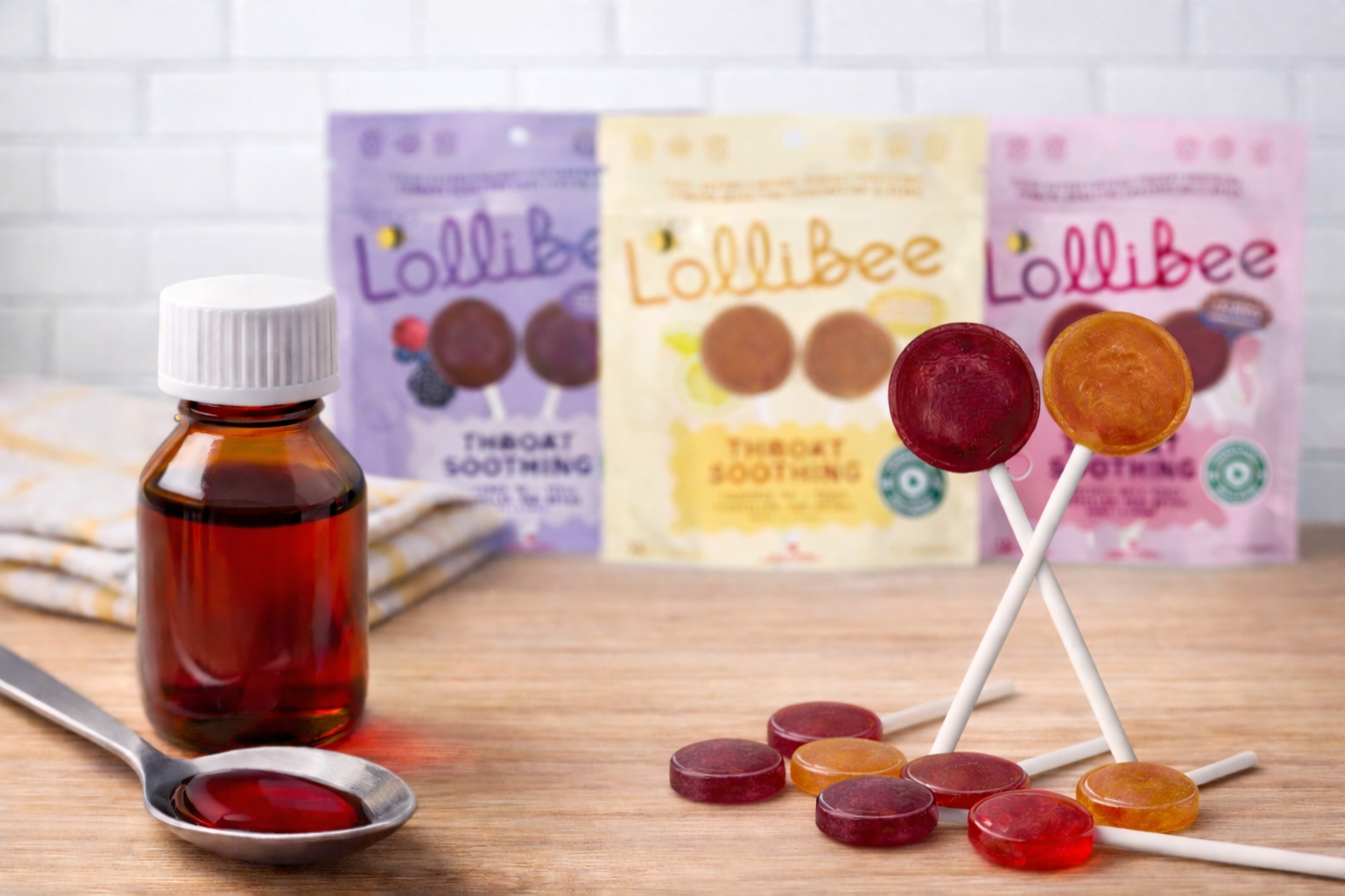 Comparison of cough syrup and throat-soothing lozenges for kids on a kitchen counter